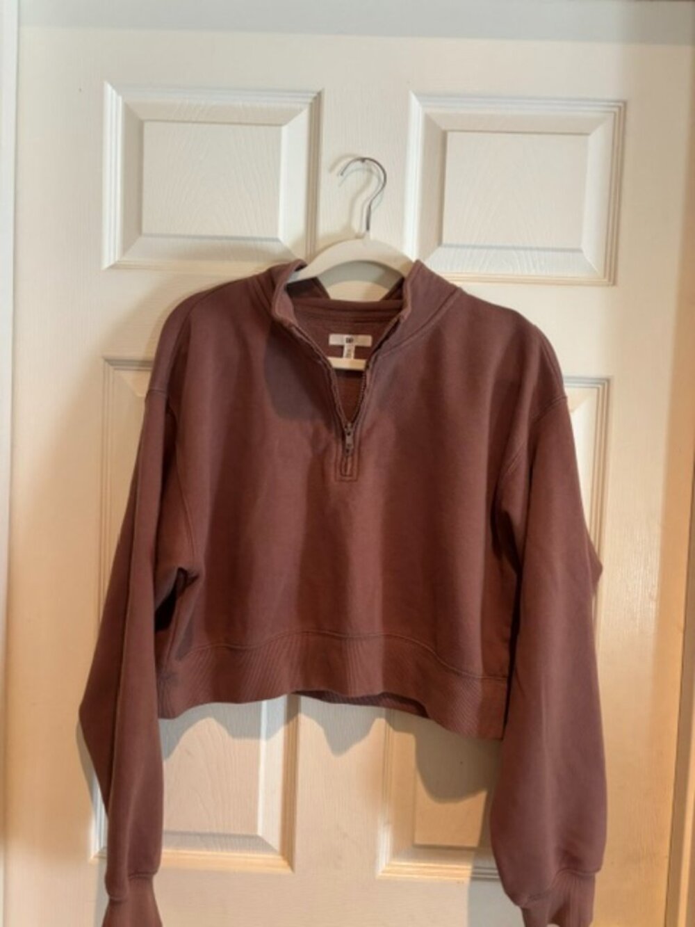 Cropped half-zip pullover sweatshirt.